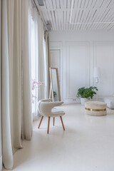 interior of a bright living room in a luxurious baroque style with white walls decorated with antique stucco