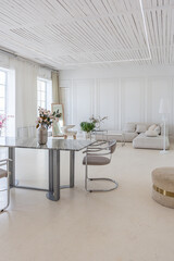 interior of a bright living room in a luxurious baroque style with white walls decorated with antique stucco