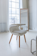 interior of a bright living room in a luxurious baroque style with white walls decorated with...