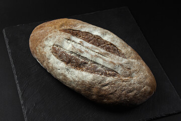 Freshly baked homemade bread on black background