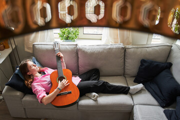 Calm teenager playing favourite song at home