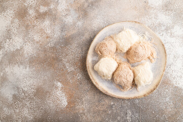 traditional arabic sweets pishmanie on brown concrete, top view, copy space.