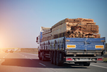 Transportation of timber wooden piles logs. Cargo for wood factories. Wooden furniture production...