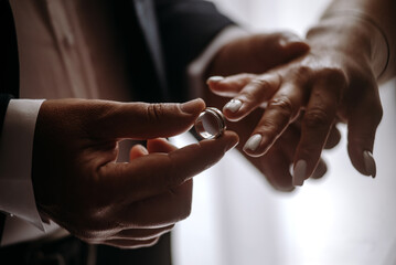 bride and groom are connected by wedding rings
