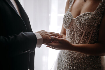 bride and groom are connected by wedding rings