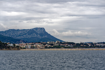 Bay of Mediterranean Sea with skyline of French City of Toulon on a cloudy late spring day. Photo taken June 9th, 2023, Toulon, France.