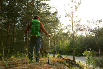 Obraz premium Mature man backpacker enjoying life trekking to explore outdoors