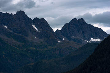 Naklejka premium View of mountain peak surrounded by clouds in Alaska, USA.