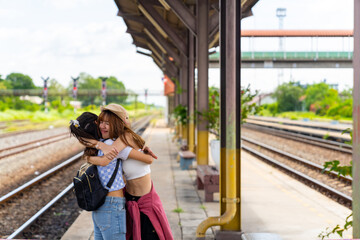 Happy Asian woman friends looking for direction on a map at railway station during travel in local town. Attractive girl enjoy and fun outdoor lifestyle travel Thailand on summer holiday vacation. 