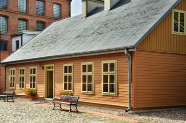 Restored old wooden house with yellow painted door and window frames