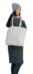 Woman holding white textile tote eco bag. Ecology or environment protection concept. White eco bag for mock up. - 646402387