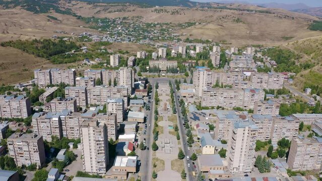 Forward reveal aerial shot of Hrazdan town on sunny summer day. Kotayk Province, Armenia.