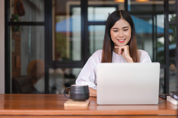 Businesswomen research data on laptop to analysis about new startup while working in outside office