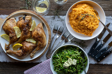Healthy and gluten free family meal with roasted chicken legs, sweet potato puree and legumes