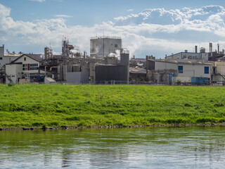 factory and green landscape in sunlight.