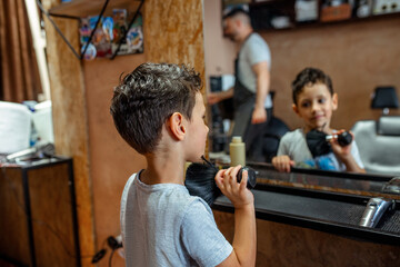 Boy sweeping cut hair from the neck