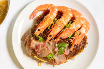 Shrimp potted with vermicelli; dipping black vinegar sauce or spicy seafood sauce. Main Ingredient is glass noodle, coriander roots, pepper, garlic, ginger and shrimp.