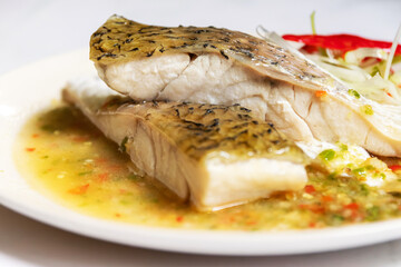 Steamed seabass fillet with lime and chillies.