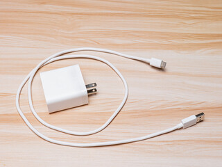 USB charger and cable type-C white color on wood table