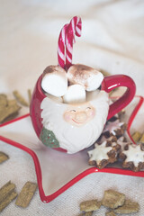 red New Year's mug with marshmallows and cookies