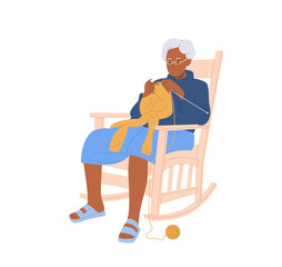 Senior woman knitting sweater with needles sitting in comfortable rocking armchair isolated on white