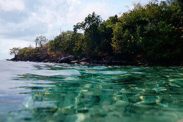 Fototapeta premium Split view above and below the water surface. Tropical bay.