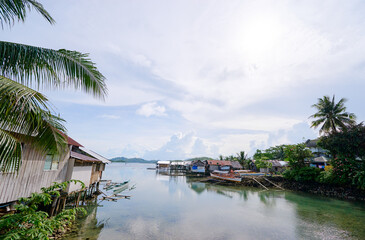 Wooden houses on stilts, tropical village on the sea shore.