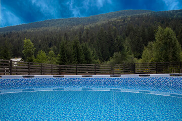 Swimming Pool in Beautiful Scenery. Outdoor Swimming Pool at Luxury Resort and Beautiful View of Mountains