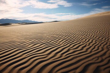 artistic shot of sand dunes, focusing on the pattern created by the wind