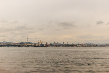 View of bosphorus strait water at mid day with light and bridge with skyline