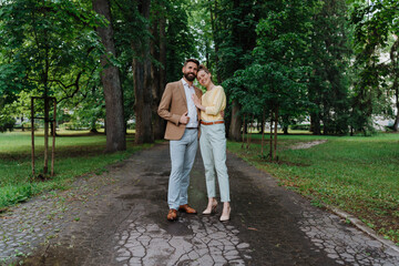 Young couple on a walk in city park after work.