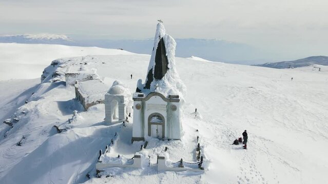 4k Drone video of a small chapel frozen in ice at the peak of the mountain Voras Kaimaktsalan winter clip 2