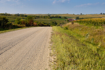 Fototapeta na wymiar gravel road through Iowa Midwest countryside in the summer