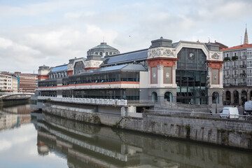 Exterior view at the Nervión river and Areatzako zubia bridge, Ribera Market, Bilbao downtown...