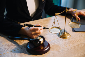 Justice and law concept.Male judge in a courtroom with the gavel, working with, computer and...