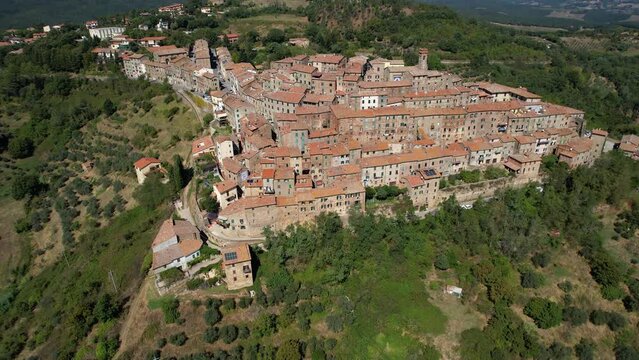 Drone flying over a magnificent authentic tuscany cityscape. Aerial view of the beautiful medieval historic center of Chiusdino, an Italian municipality in the province of Siena in Tuscany.