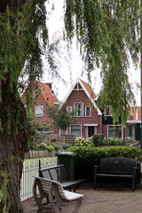 Classic Dutch houses on a street. Cute buildings with red tiles roof. Architecture of the Netherlands. 