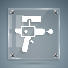 White Ray gun icon isolated on grey background. Laser weapon. Space blaster. Square glass panels. Vector