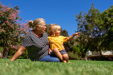 Fototapeta premium grandmother and grandson are walking in the park on a summer day