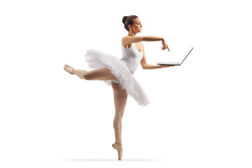 Full length shot of a ballerina dancing and using a laptop computer