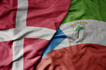 Fototapeta premium big waving national colorful flag of denmark and national flag of equatorial guinea .