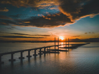 Fototapeta na wymiar Morning sunrise with cloudy sky at Penang Bridge, Penang Island, Malaysia.