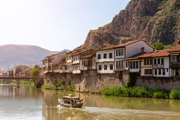 Amasya, Turkey - july 22, 2023 : Old Ottoman houses panoramic view by the Yesilirmak River in Amasya City. Amasya is populer tourist destination in Turkey.