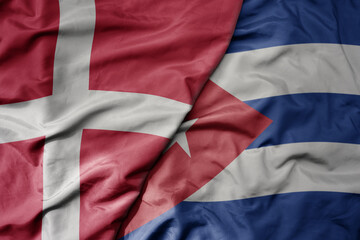 big waving national colorful flag of denmark and national flag of cuba .