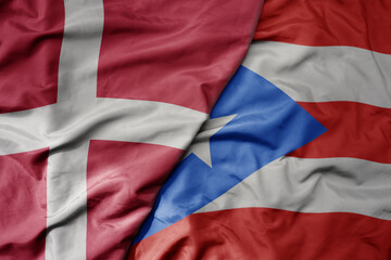 big waving national colorful flag of denmark and national flag of puerto rico .