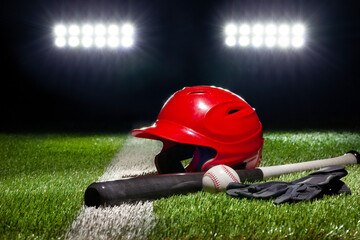 Red batting helmet bat baseball and gloves on grass field with stripe under stadium lights