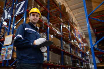 Portrait of confident male warehouse worker with digital tablet in warehouse. This is a paper package storage and distribution warehouse.