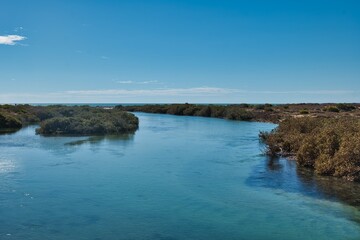 Monkey Mia's Little Lagoon, Western Australia. Channel connecting the little lagoon to the ocean. Deep blue and clear water enters a channel from the ocean.  Shark bay area, Western Australia.