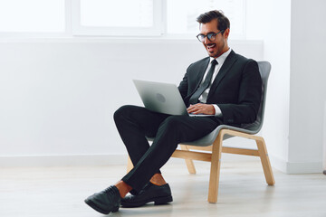 Man technology occupation winner job looking chair office laptop sitting business businessman happy