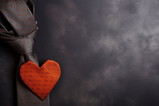 Red heart and necktie on dark background. Father's day concept.